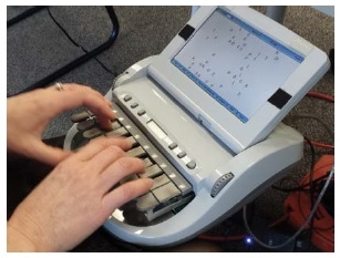 Image of Captionist typing on a stenotype machine