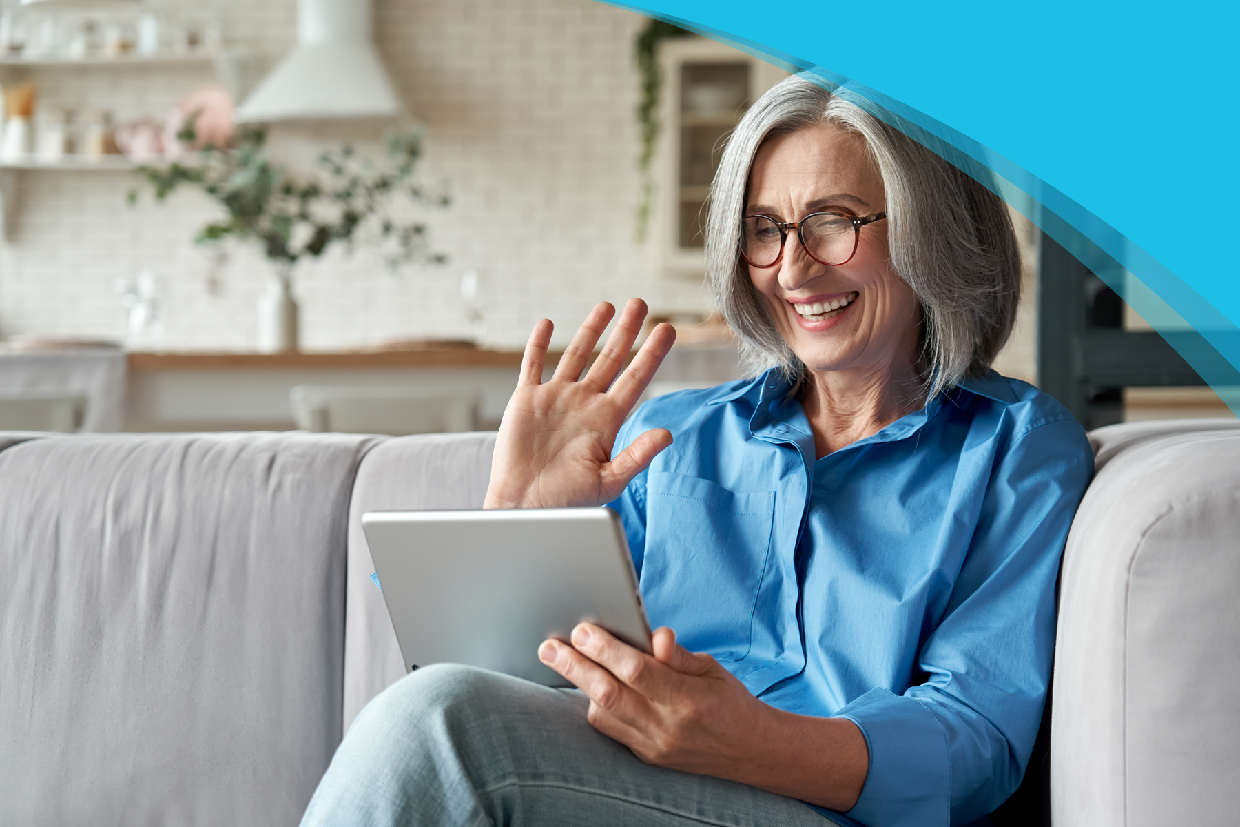 Mentor Program | Canadian Hard of Hearing Association - Older Woman using a tablet and laughing on a Couch