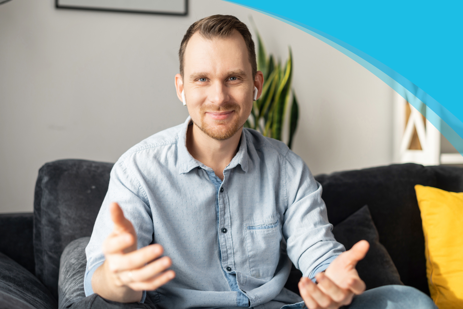 Mentor Program | Canadian Hard of Hearing Association - Man wearing airpods with arms outstretched sitting on a couch